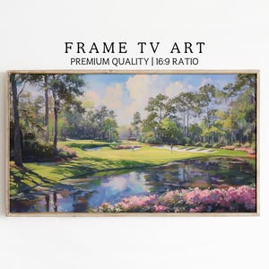 May include: A framed landscape painting of a golf course with a pond and trees. The artwork features a vibrant green golf course, a reflective pond, and lush trees under a bright sky. The text "FRAME TV ART" and "PREMIUM QUALITY | 16:9 RATIO" are displayed.