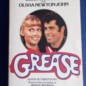 Grease paperback. Based on popular film. 1978. Includes photos from movie. 220 pgs. Pocket Books, Simon and Schuster. Grease is the word!