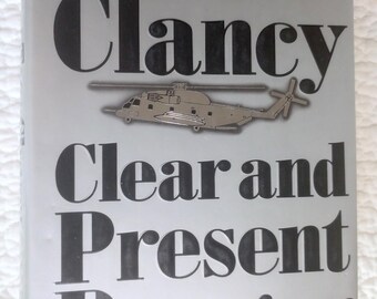 Clear and Present Danger. Tom Clancy. c.1989. First printing. Hardcover, dustjacket. Jack Ryan Book. Considered to be one of Clancy's best.