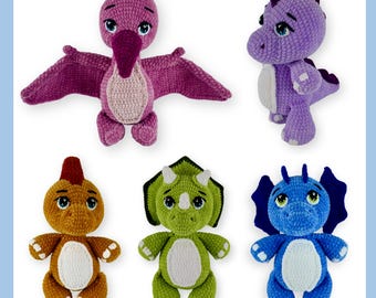 May include: A collection of six handmade crochet dinosaur toys in various colors. The toys include a purple pterodactyl with outstretched wings, a purple dinosaur, an orange dinosaur, a green triceratops, and a blue dinosaur.