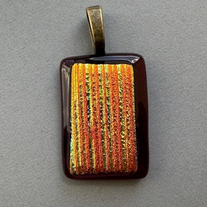 Dichroic fused gold patterned glass on red pendant