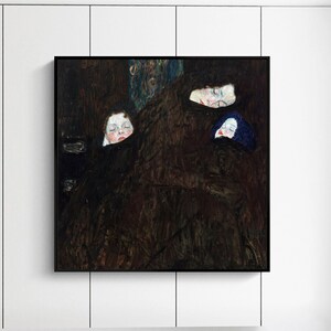 May include: A painting of four people, with only their faces visible, in a dark brown setting. The faces are pale with dark eyes and lips. The painting is framed in a black frame.