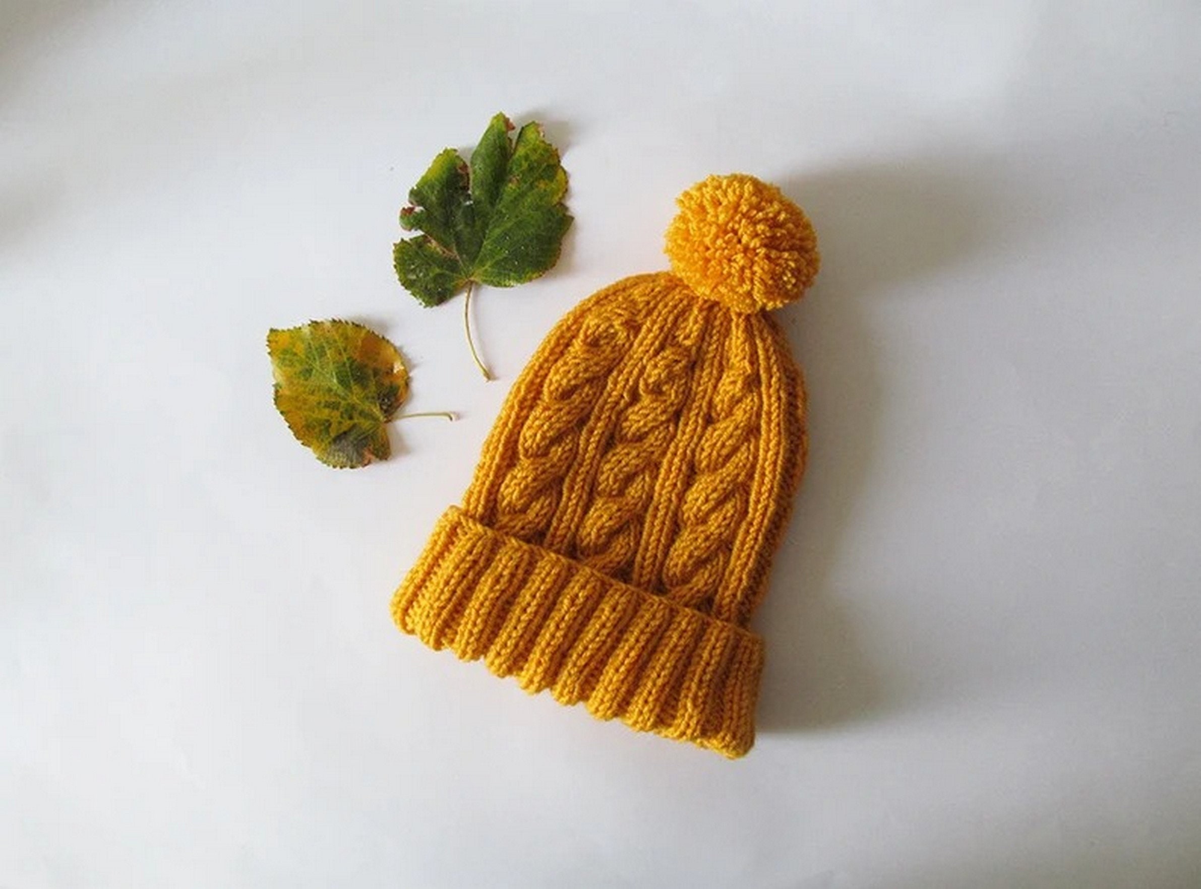 yellow hat with pom pom