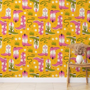 May include: A yellow background with a repeating pattern of pink and white cowboy boots, green cacti, and green snakes. The pattern is set against a yellow background with white stars and green grass.