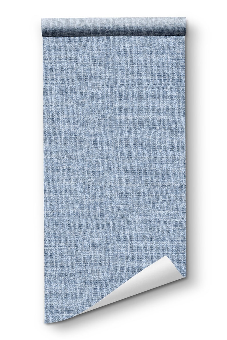 May include: A roll of blue textured wallpaper with a white background. The wallpaper is rolled up and the end is curled up.