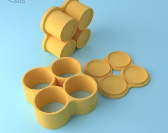 May include: A yellow plastic mold for making four round candles. The mold is shown in two parts, one with the four round molds and the other with four round bases.
