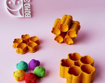 May include: A collection of orange plastic multi-cavity molds and small colorful bear-shaped figures in green, purple, yellow, and red. The text BOHO 3D is visible in the upper left corner and embossed on the side of the largest orange mold.