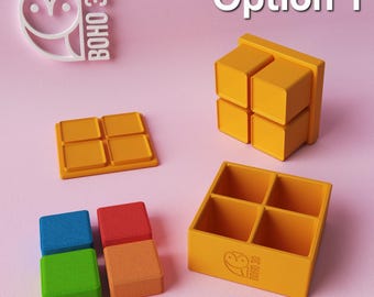 May include: Option 1 of a set of four colorful square silicone ice cube trays. The trays are arranged in a square shape with the text "BOHO 3D" printed on the bottom of one of the trays.