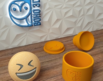 May include: Three orange 3D printed molds for making resin crafts. The molds are shaped like a smiley face, a circle, and a smaller circle. The molds are labeled "BOHO 3D".