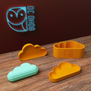 May include: Four cloud-shaped containers, two are orange and two are light blue. The containers are made of plastic and have a smooth finish. The containers are arranged on a wooden surface. The containers are labeled with the text "BOHO 3D".