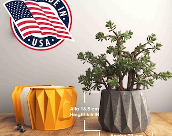 May include: A gray concrete planter with a geometric design, holding a green succulent plant. The planter is 9.06 inches wide and 6.5 inches tall. Made in the USA.