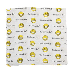 May include: White fabric with a repeating pattern of yellow smiley faces wearing face masks. The text "The Corona Kid" appears throughout the fabric.