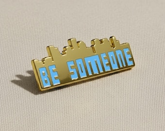 Emaljnål med "Be Someone"-motiv och Houstons skyline | 4,8 cm bred