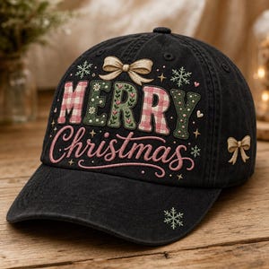 May include: A black baseball cap featuring embroidered text that reads Merry Christmas. The word Merry is in a mix of pink gingham and green floral patterns, while Christmas is in pink script. Gold bows and green snowflakes accent the design.