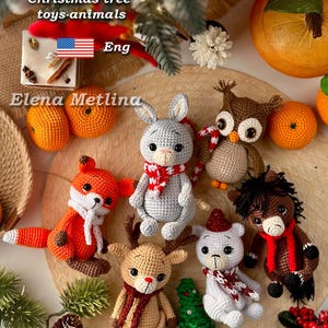 May include: A collection of handmade crochet Christmas tree toys in the shape of animals, including a fox, rabbit, owl, reindeer, bear, and horse. The toys are in various colors and feature festive scarves and hats. The image also includes text that says "PDF CROCHET PATTERN".