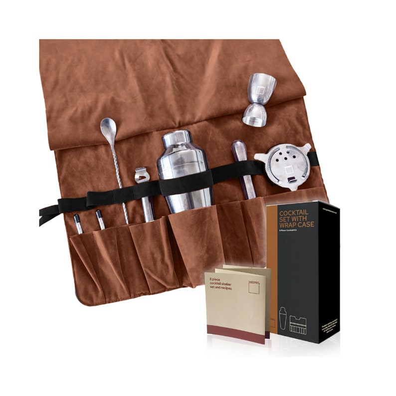 May include: A brown leather cocktail set wrap case with a silver cocktail shaker, a silver jigger, a silver bar spoon, a silver muddler, a silver strainer, and a silver cocktail stirrer. The case has a black strap and the text "Cocktail Set with Wrap Case" printed on the side.