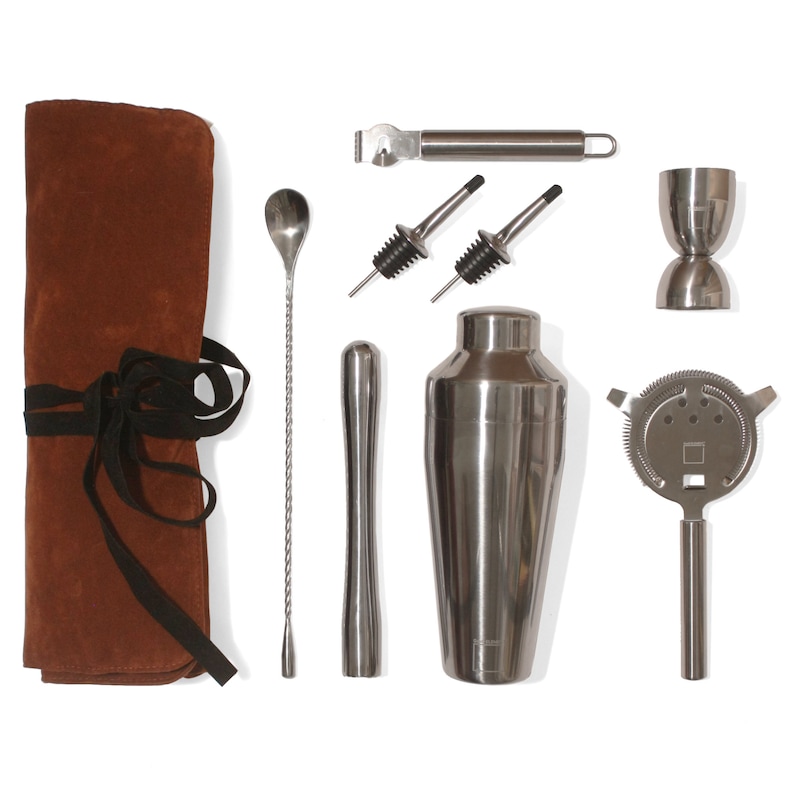 May include: A brown leatherette roll-up case with a black ribbon closure containing a cocktail shaker, a jigger, a bar spoon, a muddler, a strainer, a bottle opener, and two pour spouts.