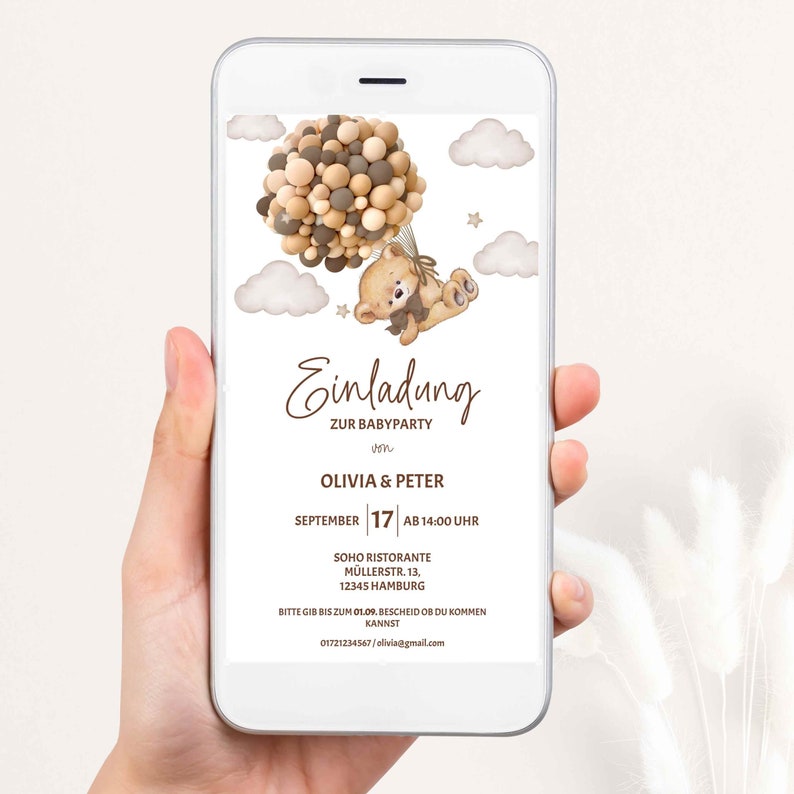 May include: A digital invitation for a baby shower with a cartoon teddy bear holding balloons. The invitation is for Olivia & Peter and is scheduled for September 17th at 2:00 PM at Soho Ristorante, M&uuml;llerstr. 13, 12345 Hamburg. The invitation includes a phone number and email address for RSVP.
