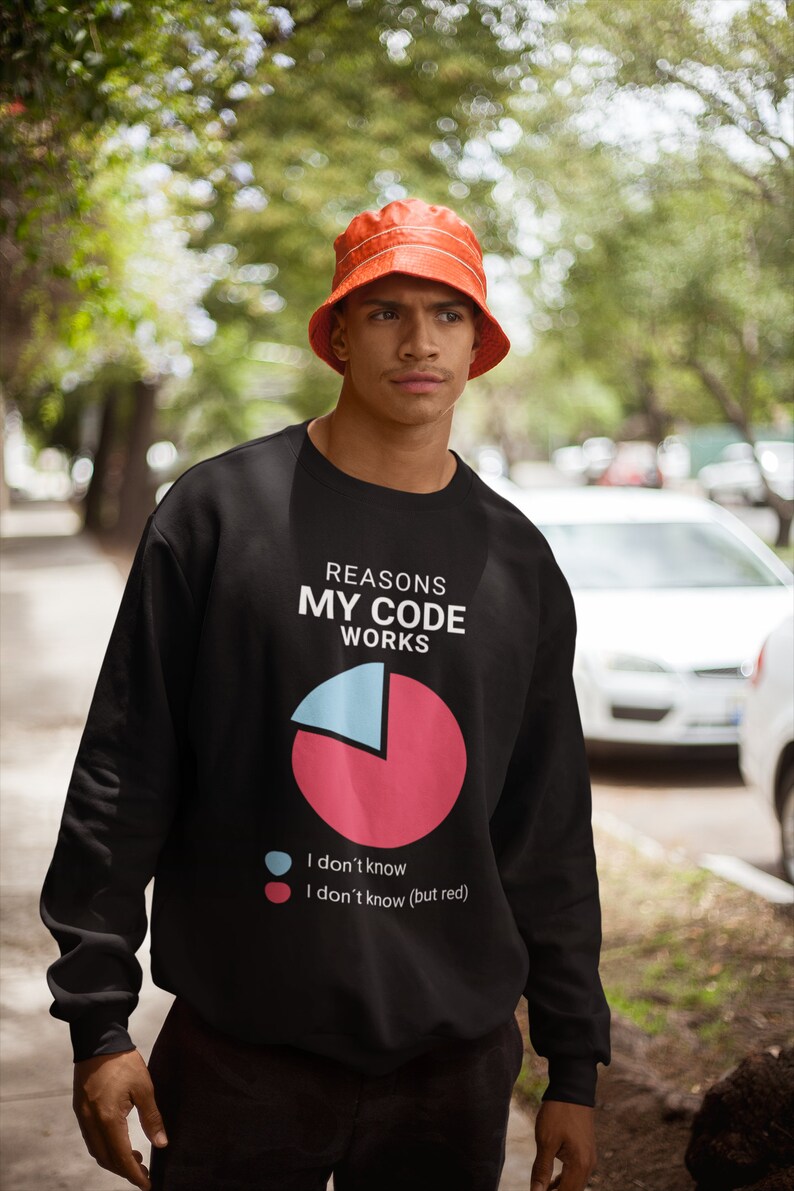 May include: A black sweatshirt with a humorous graphic of a pie chart that says "Reasons My Code Works". The chart is divided into two sections, one blue and one red. The blue section says "I don't know" and the red section says "I don't know (but red)".