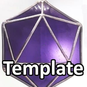 May include: A geometric, purple stained glass ornament with silver-colored metal edging. The ornament is in the shape of a 20-sided die, with the word "Template" in white block letters across the bottom. A tan string is attached for hanging.
