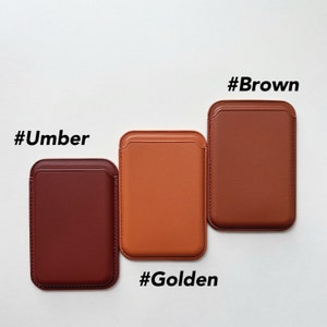May include: Three leather phone cases in different colors: brown, orange, and red. The cases are labeled with the hashtags #Brown, #Golden, and #Umber.