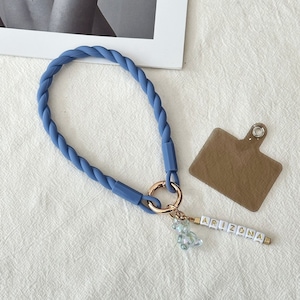 May include: A blue rope keychain with a gold ring, a clear beaded charm, and a white letter charm spelling "ARIZONA".