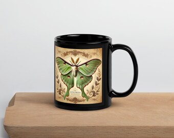 May include: Black coffee mug with a green Luna Moth illustration on a vintage-style background. The text "Luna Moth" is printed below the moth.