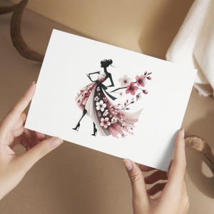 May include: A black silhouette of a woman wearing a pink and white floral dress. The dress is made of flowing fabric and has a large bouquet of pink flowers attached to the back.
