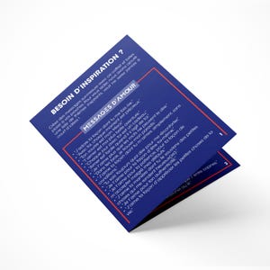 May include: A folded blue card with the text "BESOIN D'INSPIRATION?" and "MESSAGES D'AMOUR" in white. The card contains a list of inspirational messages in French. The card is on a white surface.