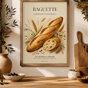 Peut inclure: Une affiche encadrée représentant une baguette dorée et des épis de blé sur fond crème. Le texte indique BAGUETTE, Traditional French Bakery, French Bakery Collection, ARTISAN BAKED + GOLDEN CRUST + FRESH DAILY, EST. 1924.