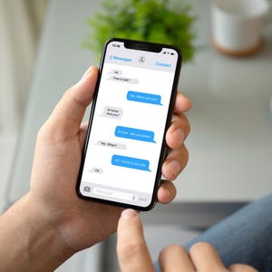 May include: A person is texting on a smartphone. The screen shows a conversation with the text "Hey, where are you?", "At home. And you?", "At work. See you this evening?", "Yes, different?", "At 7 o'clock at the cafe", "Ok".