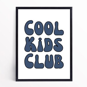 May include: A framed print with the text "COOL KIDS CLUB" in a blue, retro font style.