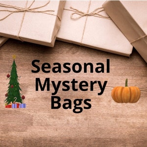May include: Three brown paper gift bags tied with twine, a small Christmas tree with decorations, and a small orange pumpkin on a wooden background. The text "Seasonal Mystery Bags" is in the centre of the image.