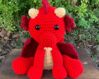 Ash le bébé dragon rouge