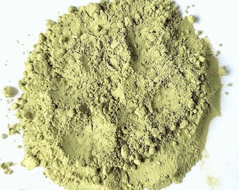 May include: A close-up of a pile of light green powder. The powder is finely ground and has a smooth texture.