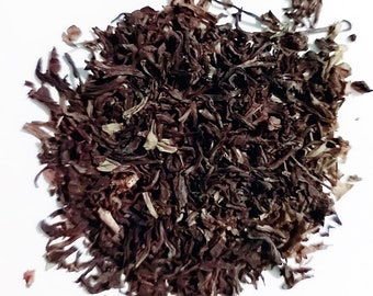 May include: Loose black tea leaves with a dark brown color. The tea leaves are dried and ready to be brewed.