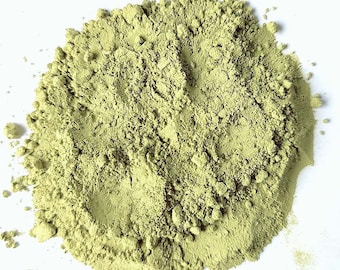 May include: A close-up of a pile of light green powder. The powder is finely ground and has a smooth texture.