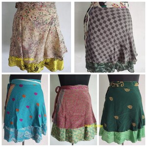 Puede incluir: Cinco estilos diferentes de faldas de envoltura hechas de saris reciclados. Las faldas son todas de diferentes colores y patrones, incluyendo floral, geométrico y paisley. Las faldas están todas hechas de seda y son muy suaves y fluidas. Las faldas tienen aproximadamente 76 cm de largo y son perfectas para cualquier ocasión.