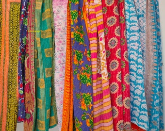 May include: A collection of colorful kantha quilts, each with a unique pattern and design. The quilts are made of recycled saris and are perfect for adding a touch of bohemian style to any room.