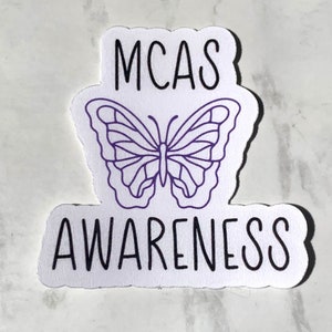 May include: White sticker with a purple butterfly and the text "MCAS AWARENESS".