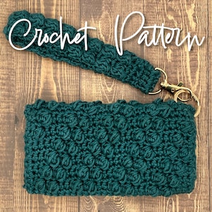 May include: Teal crochet wristlet and matching pouch with a textured stitch pattern. The wristlet has a gold-colored clasp. The words "Crochet Pattern" are written in white script across the top of the image.