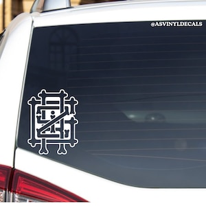May include: White vinyl decal of a stylized bone design with the text "@ASVINYLDECALS" in the upper right corner. The decal is applied to the rear window of a white car.