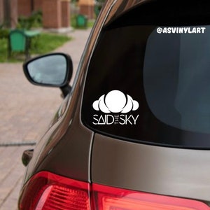 May include: A white vinyl decal with a cloud design and the text "Said the Sky" on a dark brown car.