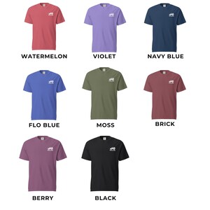 May include: A collection of nine short-sleeved t-shirts in various colors, including watermelon, violet, navy blue, flo blue, moss, brick, berry, and black. Each shirt features a small white graphic and a color name printed below.