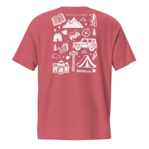 May include: A red t-shirt with a white graphic design featuring camping and outdoor adventure icons. The design includes mountains, a tent, a camera, and the text "NATIONAL PARKS" and "NOMAD.ISH".