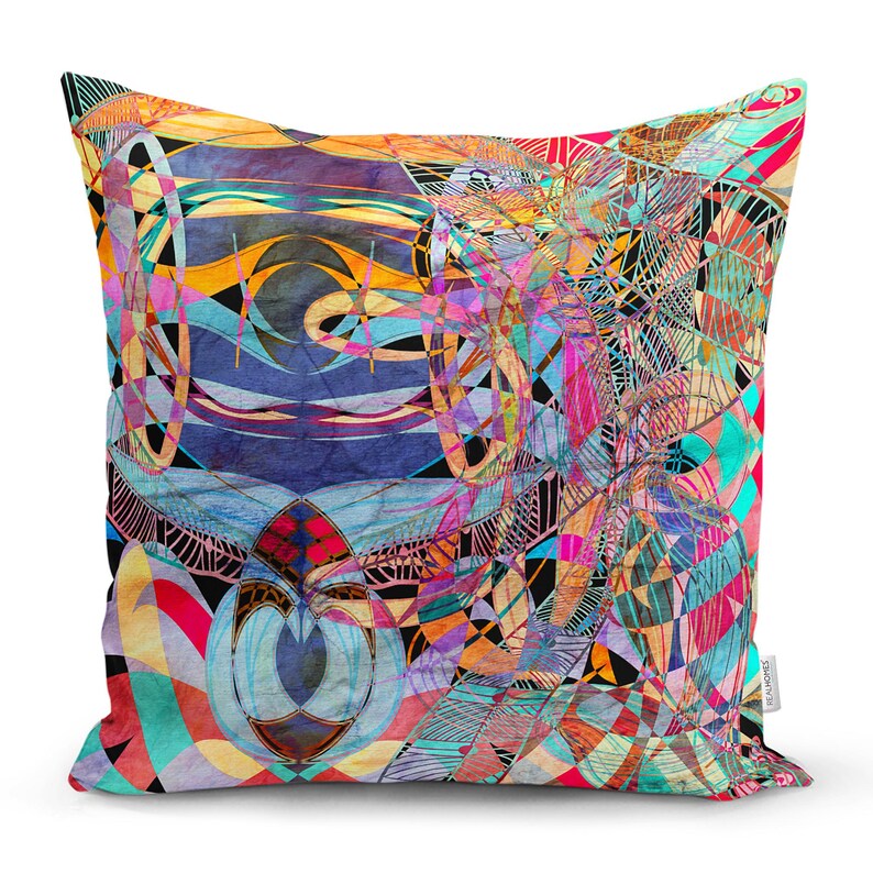 May include: A colourful throw pillow with an abstract geometric design featuring a mix of blue, pink, yellow, green, and orange hues.