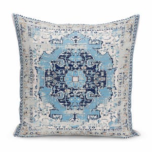 May include: A square throw pillow featuring a central medallion pattern in shades of navy blue, light blue, and cream. The design includes intricate geometric and floral motifs with a distressed texture and a decorative border.