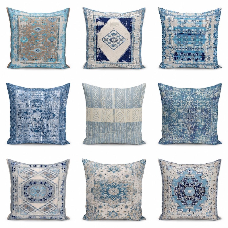 May include: A collection of nine square throw pillows featuring various blue, white, and beige patterns. The designs include intricate geometric shapes, distressed rug-inspired motifs, and symmetrical floral-like medallions on each pillow cover.