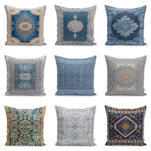 May include: Nine square throw pillows with various oriental rug-inspired designs. The pillows feature intricate patterns in shades of blue, beige, and gold. Each pillow has a different design, including medallions, geometric shapes, and floral motifs. The pillows are arranged in a three-by-three grid.