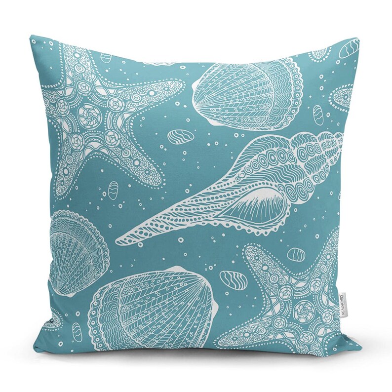 Peut inclure: Un coussin de d&eacute;coration bleu sarcelle avec un motif blanc de coquillages et d'&eacute;toiles de mer. Le motif est complexe et d&eacute;taill&eacute;.